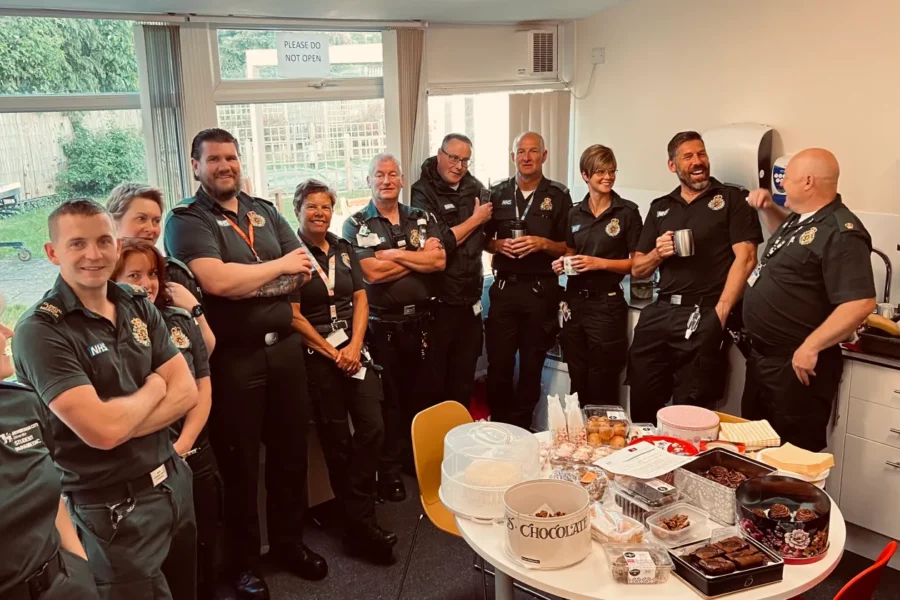 a picture of a group of paramedics with some cakes and buns