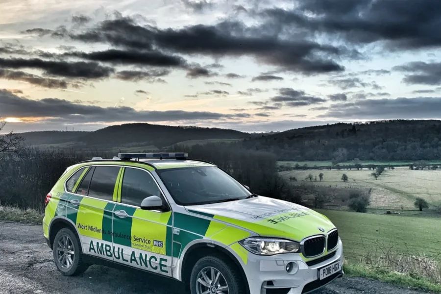 Ambulance SUV with a cloudy sky.