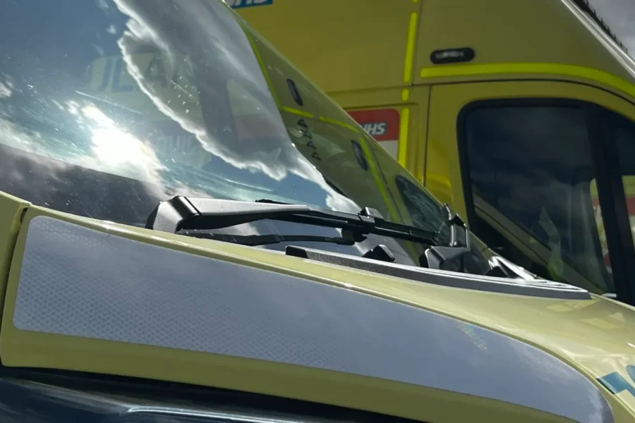 a close up of the bonnet of an ambulance and another ambulance in the background.