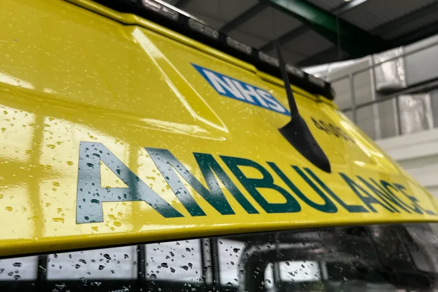 top of ambulance inside of a warehouse.